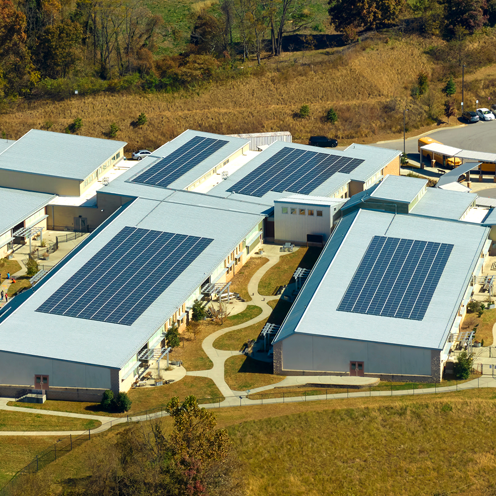 Commercial roof with solar panels, relevant to schools and businesses in Bicester.